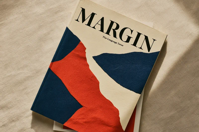 The cover of Margin magazine, the Language Issue — a bold cut-paper composition in ultramarine, red and cream
